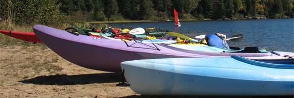 Photo: Kayaks on the Beach at Rock Lake with Aleid Sailing in the Background
Photographer: Hanzo Van Beusekom