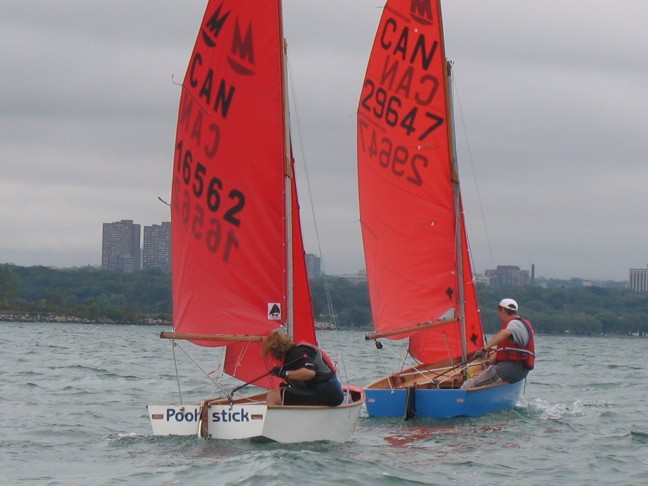 Photo: Heather Follows Mat Across the Start Line by the Committee Boat