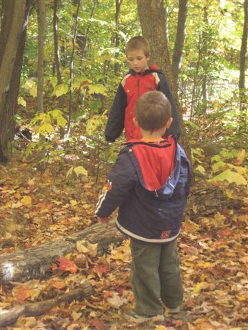 Photo: Kayden and Wyatt Discuss the Finer Points of Balancing on a Log