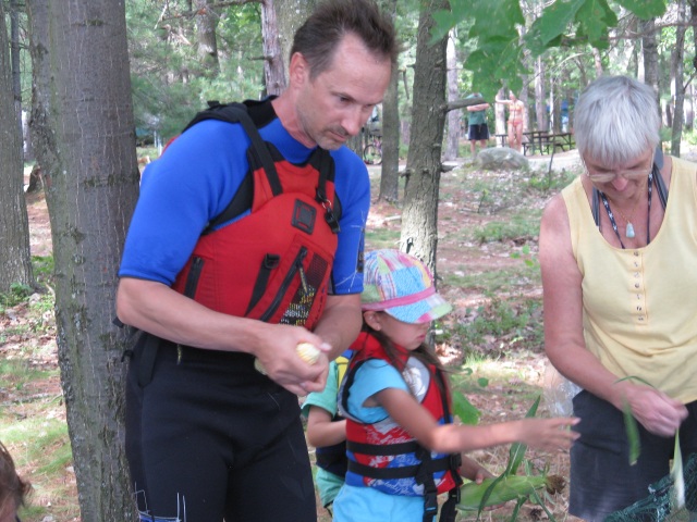 Photo: Paul, Tianna and Carol Shucking Corn