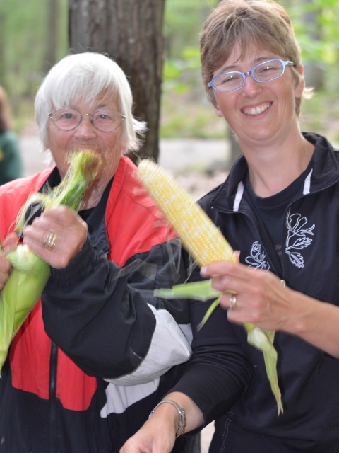 Photo: Ineke and Marika Enjoy Some Corn